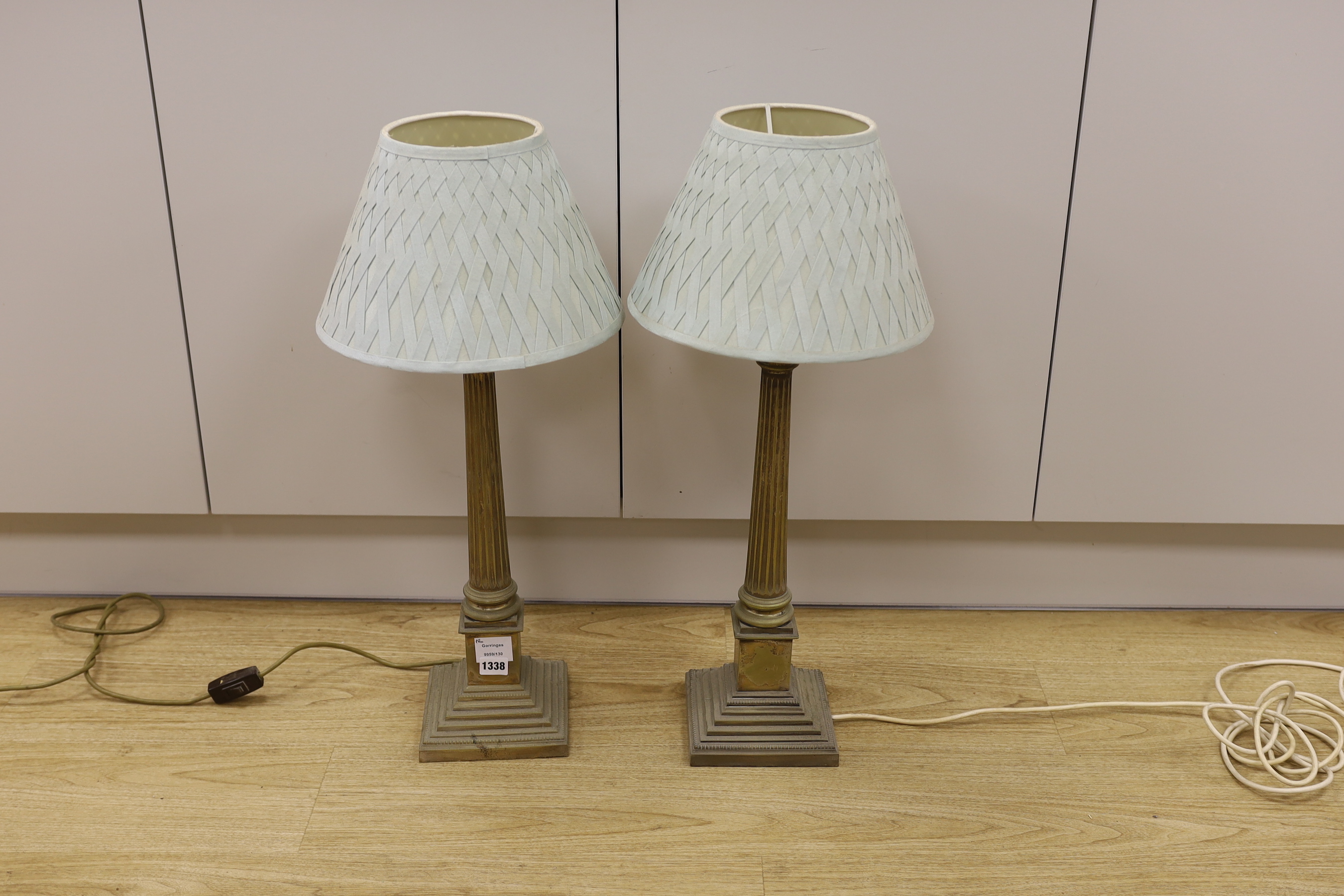 A pair of plated Corinthian column table lamps with green silk shades, 49.5cm tall